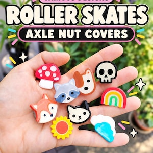 May include: A collection of small, colorful roller skate axle nut covers featuring various shapes including a red mushroom, a raccoon, a fox, a dog, a skull, a rainbow, a sun, a cat, and a cloud. The text VARIOUS DESIGNS ROLLER SKATES AXLE NUT COVERS is visible.
