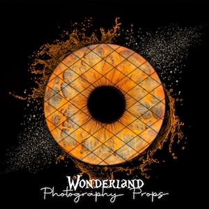 May include: A close-up of a human eye with a grid pattern over it. The eye is surrounded by a splash of orange liquid. The text "Wonderland Photography Props" is at the bottom of the image.