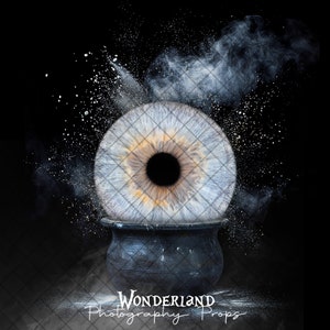 May include: A large, realistic human eye sits on top of a black cauldron. The eye is surrounded by a white powder explosion. The image is set against a black background.