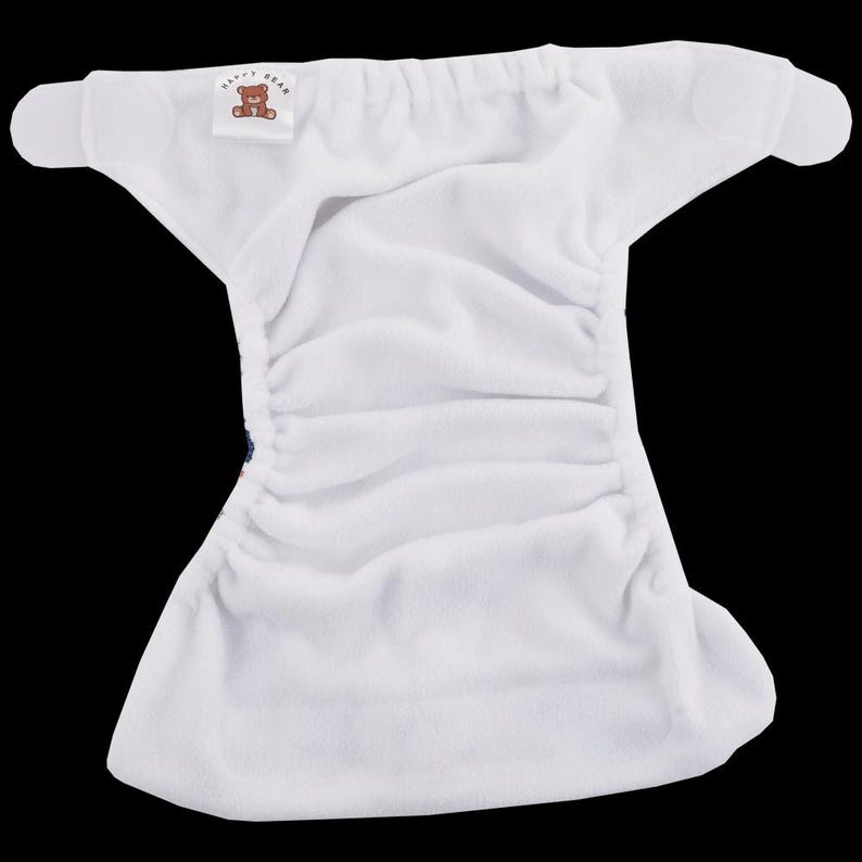May include: White cloth nappy with a velcro fastening and a small label that says "Happy Bear".