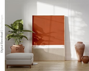 May include: A large framed abstract art piece with a textured orange and beige design. A white brushstroke divides the colors. The artwork is displayed in a room with a potted plant, ottoman, and decorative vases. The text "Digital Download | DiezDesigns" is visible.