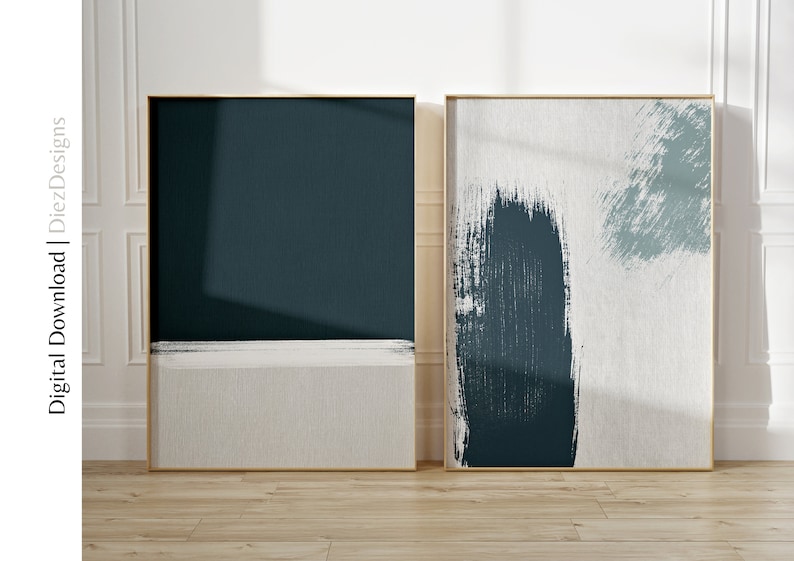 May include: Two framed abstract art prints with a teal and white color scheme. The print on the left is a solid teal color with a thin white stripe across the bottom. The print on the right has a white background with teal brushstrokes.