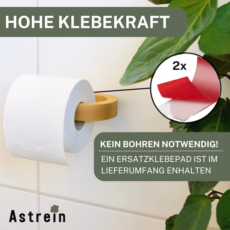 May include: A wooden toilet paper holder with a white roll of toilet paper. The holder is attached to a white tiled wall with a strong adhesive pad. The text "HOHE KLEBEKRAFT" is visible at the top of the image. The text "KEIN BOHREN NOTWENDIG! EIN ERSATZKLEBEPAD IST IM LIEFERUMFANG ENTHALTEN" is visible at the bottom of the image. The text "2x" is visible in a red circle.