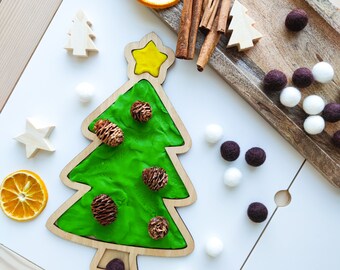 Christmas tree shaped sensory play board. Wooden tinker sorting tray for homeschool lessons.
