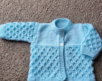 Hand knitted baby cardigan / matinee coat in soft pale blue baby wool Elaborate pattern.