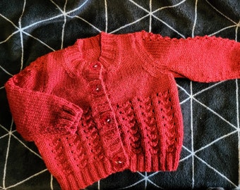 Hand knitted baby cardigan in soft dark cherry red wool in a cute pattern with matching buttons - perfect for Christmas outfit