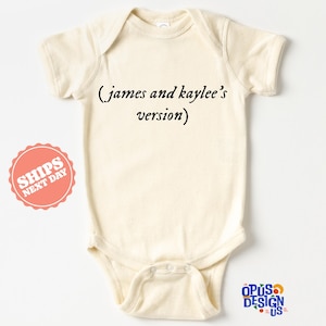 May include: A cream-colored baby onesie with the text "(james and kaylee's version)" printed on the front.