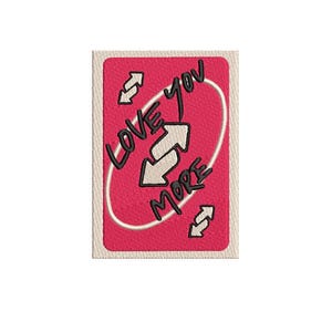 May include: A red card with the words "LOVE YOU MORE" in black script and a white oval with two arrows. The card has a white border and a stitched texture.