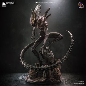 Può includere: Una statuetta di creatura biomeccanica scura con una testa liscia e allungata, artigli affilati e una coda segmentata che si curva attorno alla base. La figura poggia su un piedistallo strutturato dall'aspetto organico con piccole uova alla base.