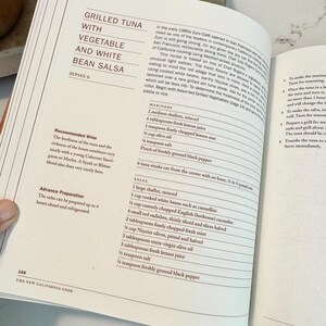 May include: Open cookbook page with a recipe for Grilled Tuna with Vegetable and White Bean Salsa. The recipe includes ingredients for marinade and salsa, with a wine recommendation. The page is from "The New California Cook."