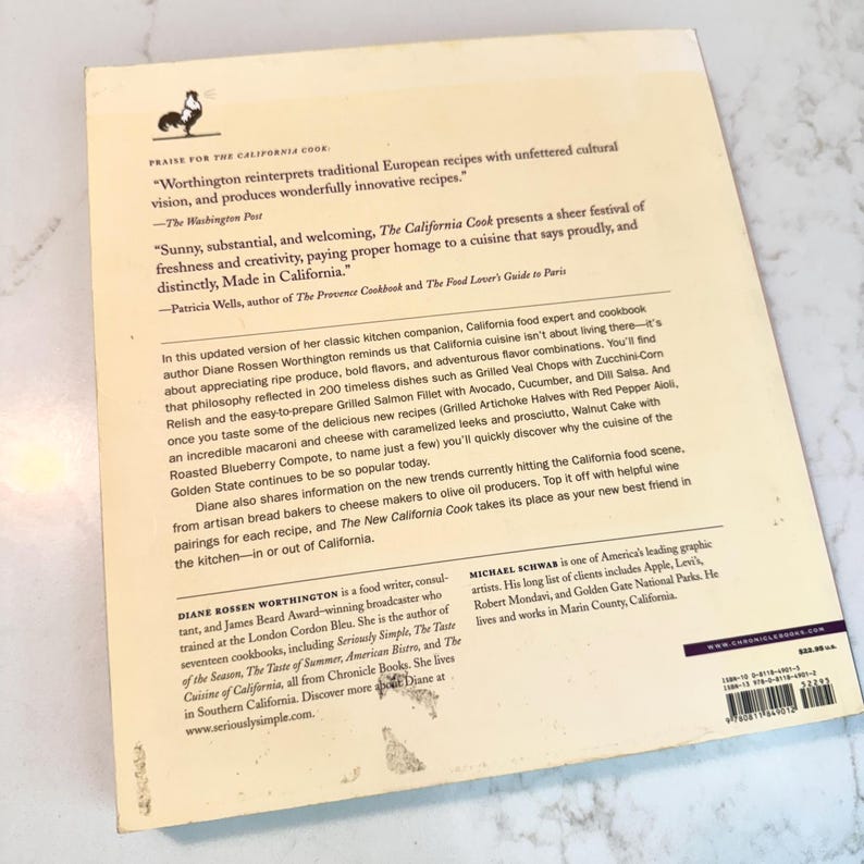 May include: A cookbook titled "The California Cook" with text and a rooster illustration. The book features quotes about California cuisine and mentions recipes like Grilled Veal Chops and Grilled Salmon Fillet. The author is Diane Rossen Worthington.