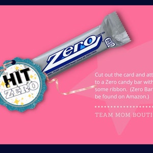 May include: A blue and white tag with the text "HIT ZERO" on a pink background. A silver candy bar with the text "ZERO" is partially visible in the background. The text "Cut out the card and attach to a Zero candy bar with some ribbon. (Zero Bars can be found on Amazon.) TEAM MOM BOUTIQUE" is also visible on the pink background.
