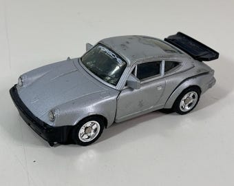 Coche robot Porsche 930 Turbo Bandai a escala 1/37 (1984)