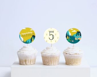 May include: Three cupcakes with yellow and blue camping themed cupcake toppers. The toppers say "Happy Birthday Harrison", "5", and a camper with a tent and trees.
