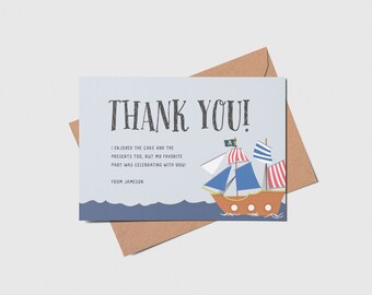 May include: A blue and white thank you card with a cartoon pirate ship sailing on the ocean. The card says "Thank You!" and "I enjoyed the cake and the presents too, but my favorite part was celebrating with you!"  From Jameson.