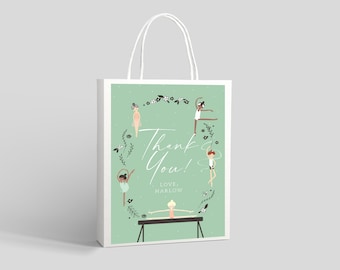 May include: A green thank you gift bag with a white handle. The bag features a design of five girls doing gymnastics with a floral wreath around them. The text "Thank You! Love, Harlow" is printed on the bag.