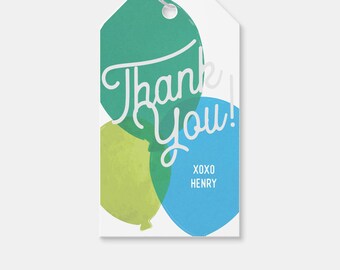 May include: Thank you gift tag with a watercolor design of three balloons in shades of green, blue, and yellow. The text "Thank You!" is written in white cursive font. The tag also includes the text "XOXO HENRY" in white font.