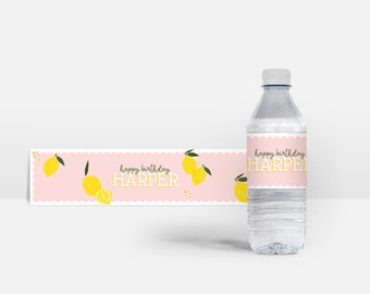 May include: Pink and white water bottle label with a lemon design and the text "happy birthday HARPER".
