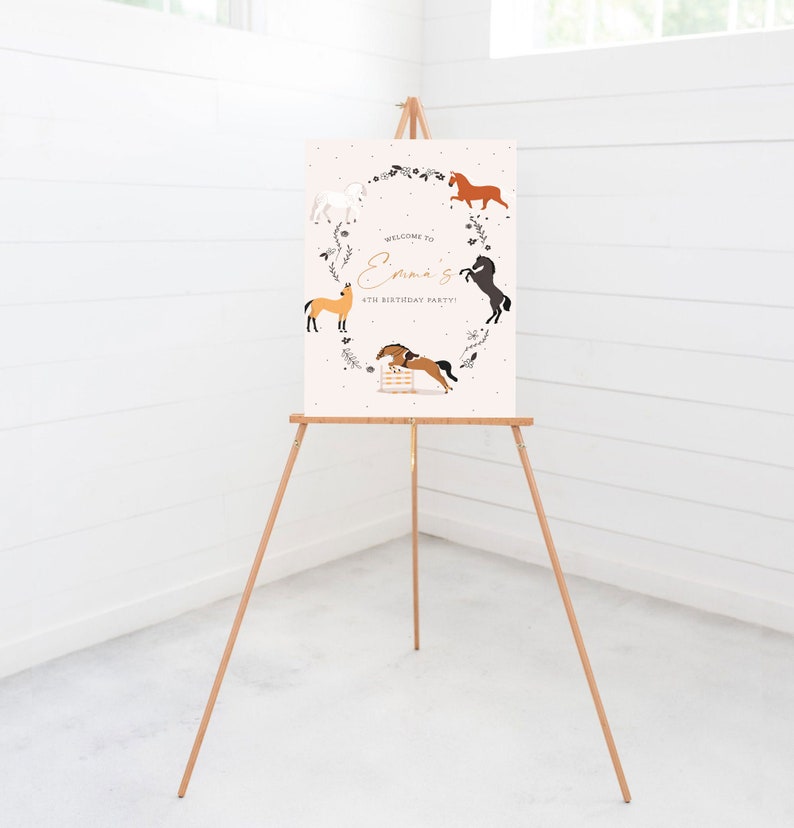 May include: Welcome to Emma's 4th Birthday Party! A pink sign with a white border features a wreath of flowers and five horses in different poses. The sign is displayed on a wooden easel.