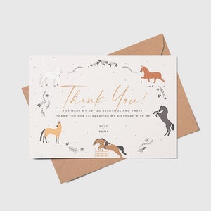 May include: Thank You! card with a white background and a gold handwritten thank you message. The card is decorated with a floral wreath and five horses in different colors and poses. The text on the card reads "You made my day so beautiful and sweet! Thank you for celebrating my birthday with me! XOXO Emma"