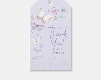 May include: Purple thank you tag with a butterfly theme. The tag features a large white butterfly with pink and purple accents, surrounded by smaller butterflies in various colors. The text "Butterfly Kisses & Birthday Wishes" is printed in a light purple font. The text "Thank You!" is written in a handwritten style, followed by "Love Camila".