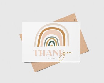 May include: A thank you card with a rainbow design in shades of brown, pink, and green. The text "THANK you" is written in a pink font with the name "KOKO ISABELLA" written below in a smaller font.