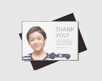 May include: A thank you card with a photo of a young boy smiling. The card has a blue and red race car illustration and the text "THANK YOU! I enjoyed the cake and the presents too. But my favorite part was racing with you! From Ethan."