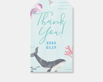 Può includere: Un'etichetta di ringraziamento blu e bianca con una balena, coralli e una medusa. Il testo recita "Grazie! XOXO Riley".