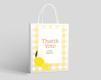 May include: White gift bag with yellow and white gingham pattern. The bag has a white label with the text "Thank You! XOXO Harper" and a lemon illustration.