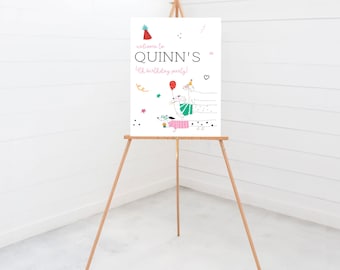 May include: Welcome to Quinn's 4th birthday party! A white sign with a colorful illustration of dogs wearing party hats and holding balloons. The sign is on a wooden easel.