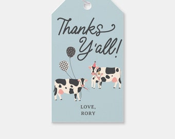 May include: A blue thank you tag with a cow and calf wearing party hats and holding balloons. The text on the tag reads "Thanks Y'all! Love, Rory".
