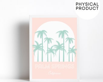 May include: A pink and white framed print with a graphic of palm trees and the text "PALM SPRINGS California".