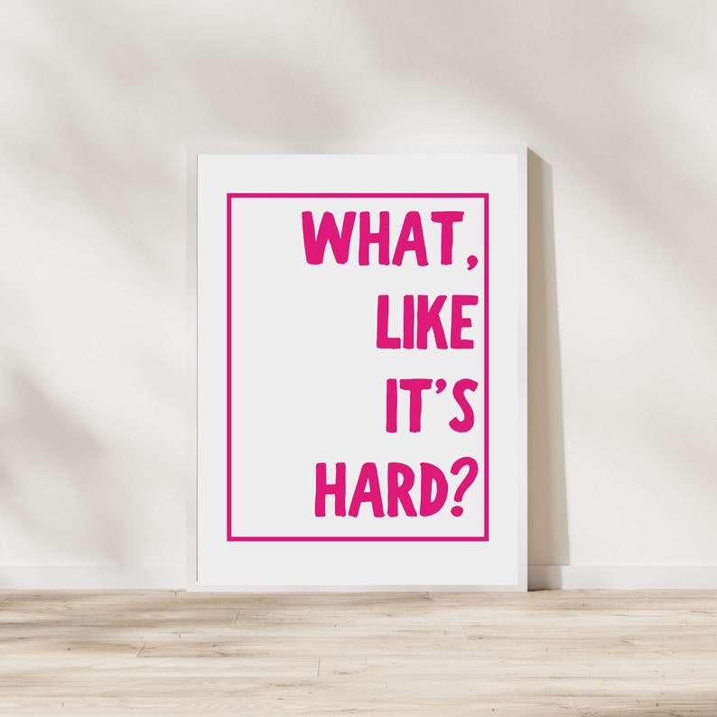 Może przedstawiać: Biały wydruk w ramie z tekstem "WHAT, LIKE IT'S HARD?" w r&oacute;żowych literach.