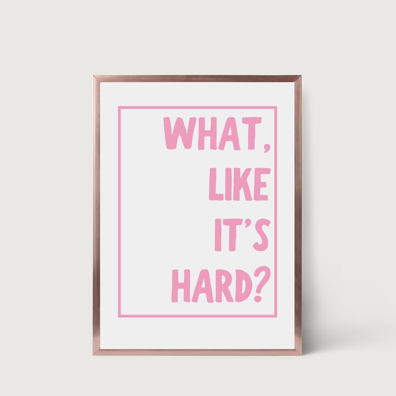 Może przedstawiać: Biały wydruk w ramie z r&oacute;żowym nadrukiem tekstu "WHAT, LIKE IT'S HARD?"