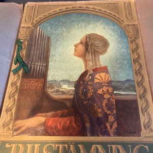 May include: A vintage illustration of a woman in a white veil and a purple and gold robe playing a pipe organ. The image is framed in gold and has the text "JULSTAMNING" at the bottom.
