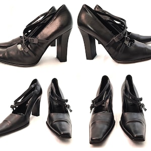 May include: Black leather heeled shoes with a pointed toe and multiple straps across the foot. The shoes have a chunky heel and a buckle detail.