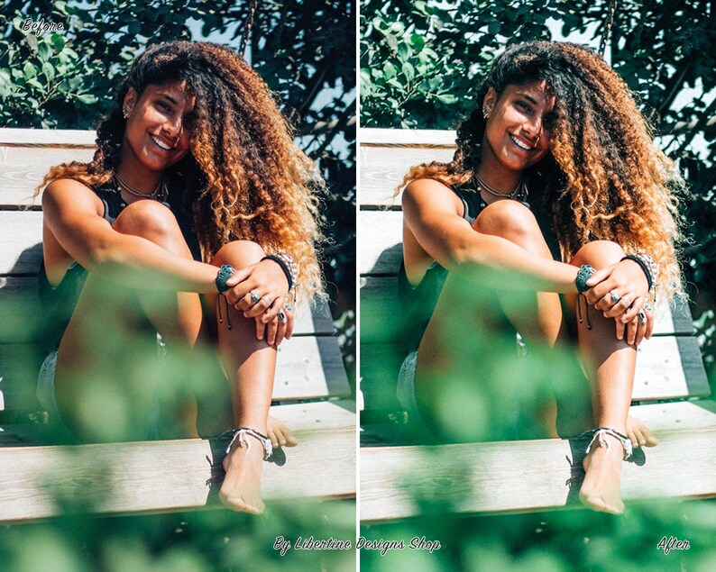May include: A woman with long curly brown hair sits on a wooden bench with green foliage in the foreground. She is wearing a black tank top and a silver necklace. She is smiling and looking at the camera.