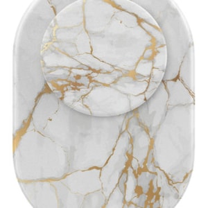 May include: White oval-shaped coaster with a gold marble pattern. The coaster has a smaller, round coaster with the same pattern on top.