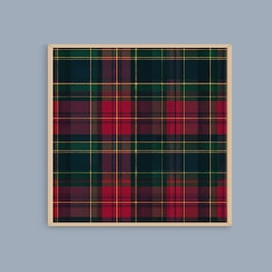 May include: A framed print featuring a tartan pattern in shades of red, green, yellow, and navy blue. The plaid design has a traditional woven appearance, with intersecting lines creating a grid-like structure. The frame is a light beige color.
