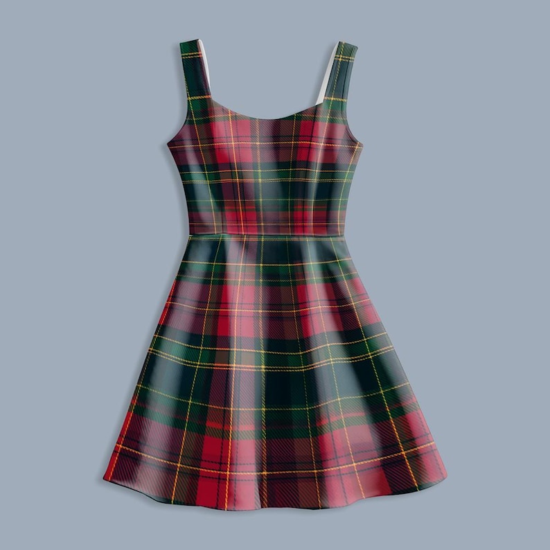 May include: A sleeveless dress featuring a classic plaid pattern in red, green, and yellow. The dress has a fitted bodice and a flared skirt, with thin shoulder straps. The fabric has a smooth texture, and the overall design is a timeless style.