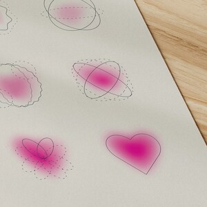 May include: A white print with abstract pink shapes and the words "think we deserve" in black. The print features various designs, including a heart and other geometric forms, with the text "e love" at the top.