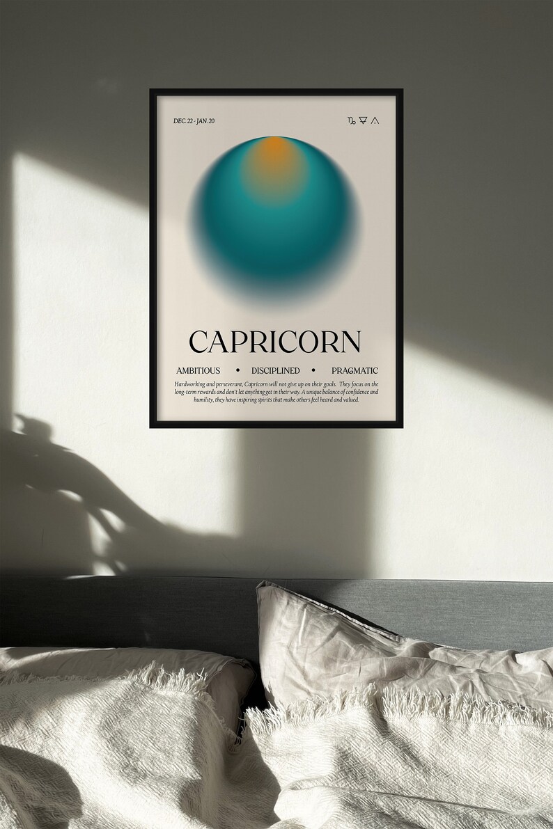 May include: Capricorn zodiac art print in a black frame. The poster features a teal and orange gradient sphere, the word "CAPRICORN", and the dates "DEC. 22 - JAN. 20". The print also lists the traits: ambitious, disciplined, and pragmatic.