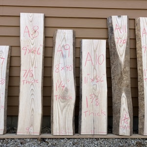 May include: Six pieces of wood planks labeled A7 through A12 with measurements and thickness in inches. The planks are arranged vertically against a brown wall.