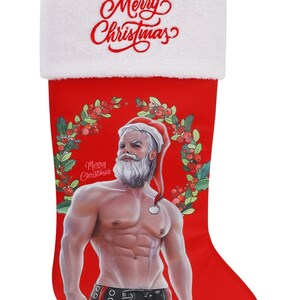 May include: Red Christmas stocking with a white cuff. The stocking features a muscular Santa Claus with a white beard and a wreath of holly around his head. The stocking has the text "Merry Christmas" on the cuff and "Merry Christmas" on the Santa Claus.