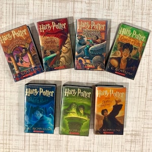 May include: A collection of seven Harry Potter books by J.K. Rowling, including The Sorcerer's Stone, The Chamber of Secrets, The Prisoner of Azkaban, The Goblet of Fire, The Order of the Phoenix, The Half-Blood Prince, and The Deathly Hallows.