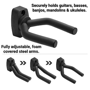 Black guitar wall mount with foam covered arms. The mount is adjustable and can be used to hold guitars, basses, banjos, mandolins, and ukuleles. The text 'Securely holds guitars, basses, banjos, mandolins & ukuleles. Fully adjustable, foam covered steel arms.' is displayed on the image.