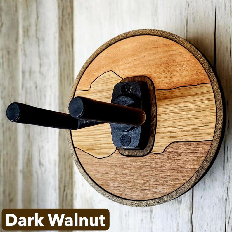 Dark walnut hardwood guitar hanger wall mount with circular backer and black foam covered steel support arms
