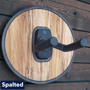 Handcrafted spalted wood guitar wall hanger with circular backer and adjustable padded instrument support arms