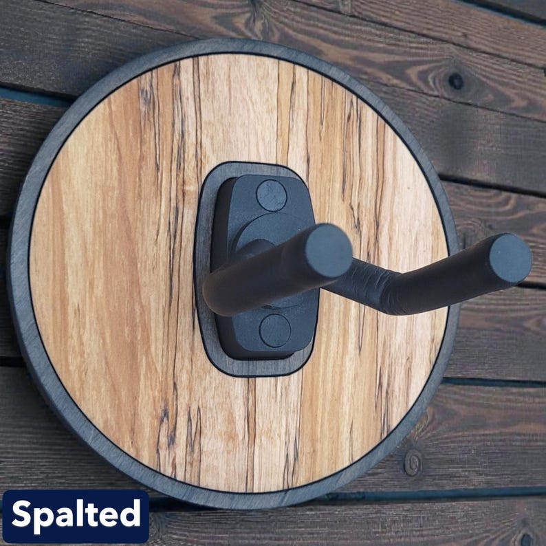 Handcrafted spalted wood guitar wall hanger with circular backer and adjustable padded instrument support arms