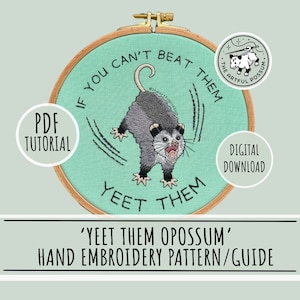 May include: A teal embroidery hoop with a hand-stitched design of a possum with the text "If you can't beat them, yeet them" around it. The possum is gray and white and has a surprised expression. The text "Yeet them possum" is written below the hoop.